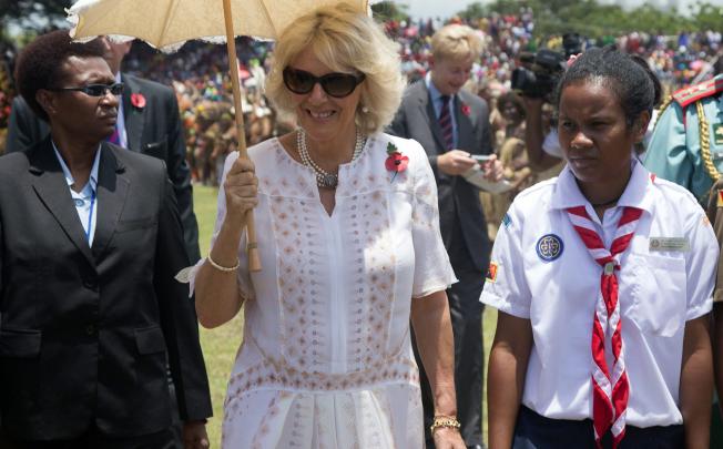 Camilla, Duchess of Cornwall, walks next to a girl scout through Sir John Guise Stadium, Papua New Guinea. Photo: EPA