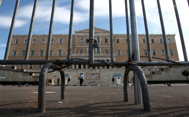 Fences have been placed around the Greek parliament, ahead of the 48-hour nationwide general strike, in central Athens. Photo: AP