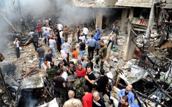 Syrian citizens gathering at the site of bomb explosion at the Mazzeh Jabal area in Damascus. Photo: EPA