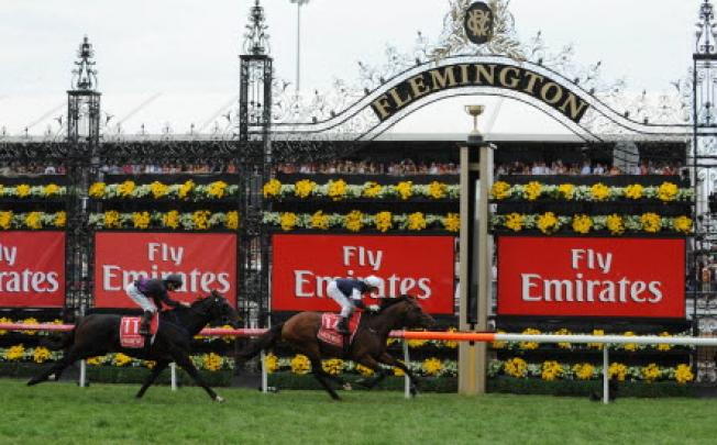 Irish stayer Green Moon, ridden by Hong Kong-based jockey Brett Prebble, beats Fiorente (James McDonald) to win the 152nd Melbourne Cup at Flemington on Tuesday. Photo: AFP