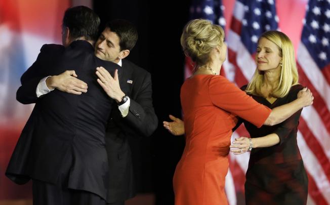 Mitt Romney (above left) embraces running mate Paul Ryan after conceding the race. Photo: AP