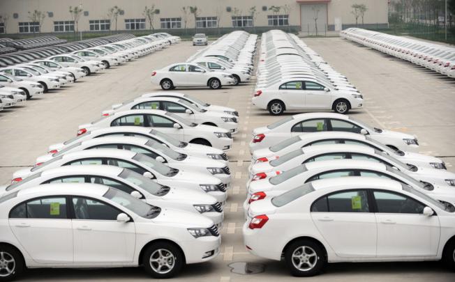 Rows of Emgrand cars are parked at Geely's car plant in Hangzhou, the marque's global headquarters.
