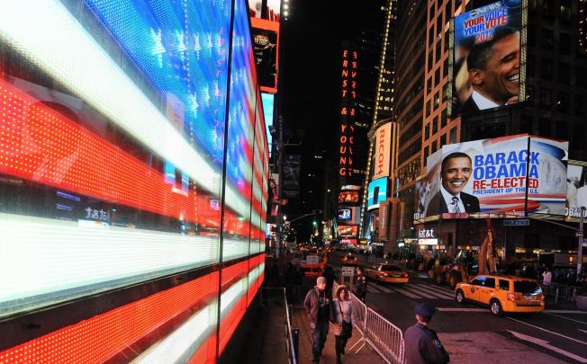 President Barack Obama's re-election is announced in New York's Times Square. The results were forecast with uncanny accuracy by young mathematicians. Photo: EPA