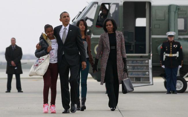 US President Barack Obama, first lady Michelle Obama and their daughters Sasha, left, and Malia return to Washington following Obama's second-term win on Tuesday. Photo: Reuters