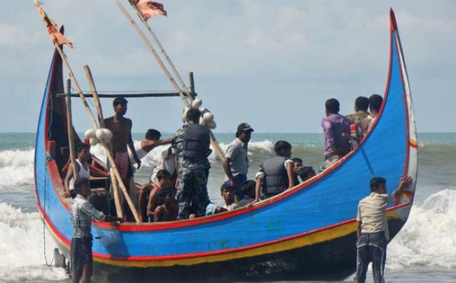 Bangladesh Border Guard soldiers check survivors rescued from a boat that capsized in Teknaf, Bangladesh, on Wednesday. Photo: AP