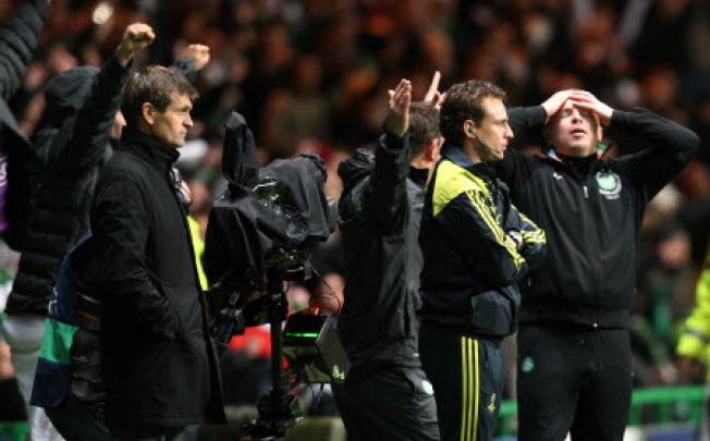Barcelona manager Tito Vilanova, left, stand's dejected after being defeated by Celtic at the end of their Champions League Group G soccer match at Celtic Park, Glasgow, Scotland on Wednesday. Photo: AP 