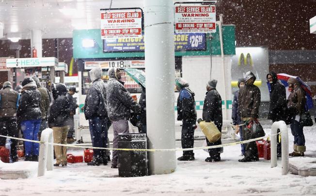 People queue up for petrol in snowy Brooklyn. Photo: AFP