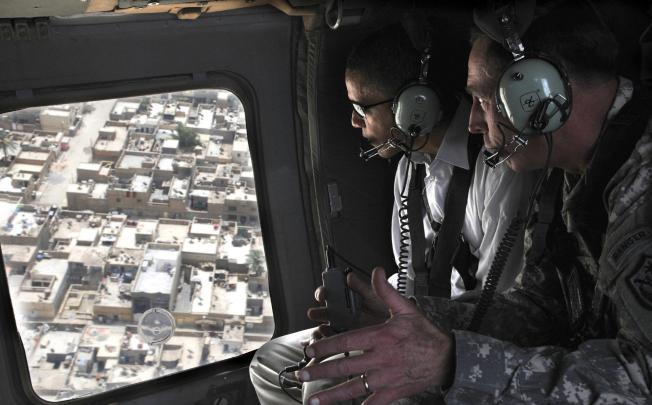 Then presidential candidate Barack Obama (left) takes a helicopter ride over Baghdad with David Petraeus in July, 2008. Photo: AP
