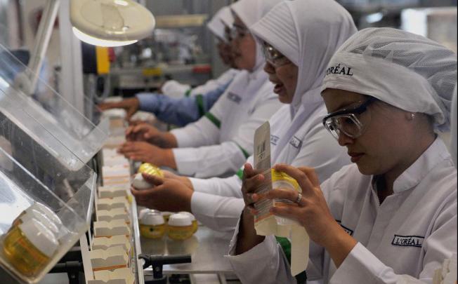Workers pack cosmetic products at a factory in Jakarta. Indonesia aspires to become an Asian manufacturing centre. Photo: Xinhua