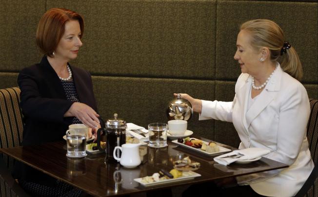 Prime Minister Julia Gillard (left) has a cup with Hillary Clinton in Perth. Photo: AFP
