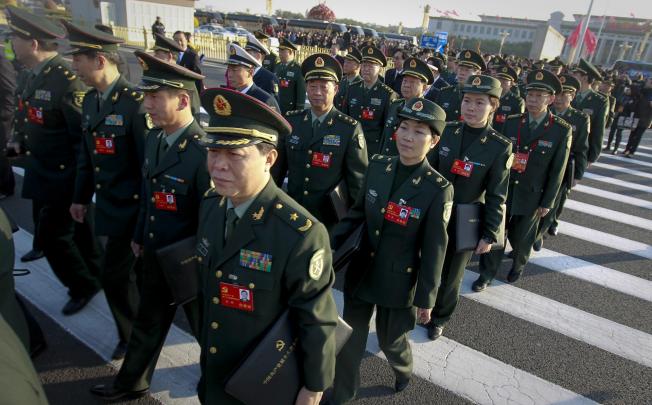 PLA delegates walk towards the Great Hall of the People during the recent Communist Party Congress held in Beijing. Photo: EPA
