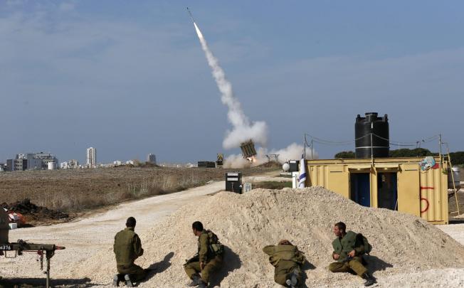 Israeli soldiers watch as an Iron Dome launcher fires an interceptor rocket near the southern city of Ashdod. Photo: Reuters