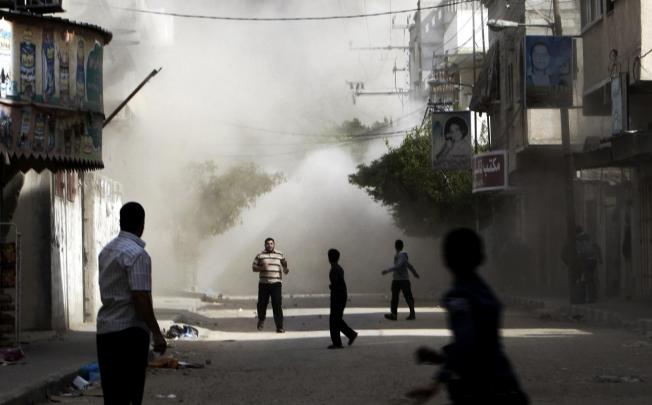 A building in Gaza is hit during an Israeli air strike. Photo: AP