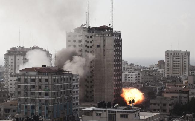 Smoke billows from the Shuruq tower in Gaza, which houses several media offices, after being hit by an Israeli air strike on Monday. Photo: EPA