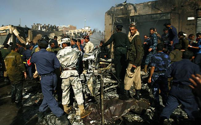 Rescuers work at the scene of a plane crash in Sanaa on Wenesday. Photo: AP