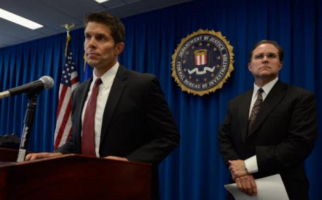 David Bowdich, (left) an FBI special agent speaks during a news conference to announce the arrest of four people from Southern California on terrorism charges as Bill Lewis, an FBI assistant director looks on. Photo: AFP