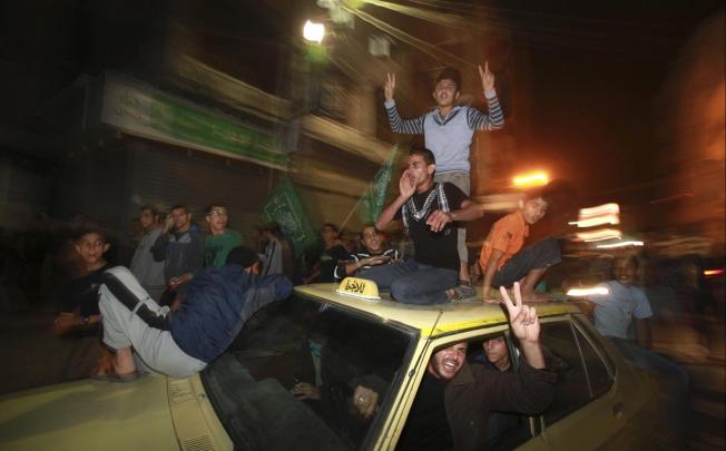 Palestinians in Gaza City celebrate what they say is a victory over Israel after an eight-day conflict. Photo: Reuters