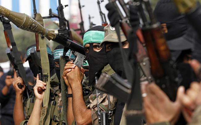 Members of the Ezzedine al-Qassam brigades, the armed wing of Hamas, celebrate the truce at Nusseirat refugee camp in the central Gaza Strip. Photo: AFP