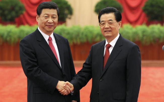 Hu Jintao, right, shakes hands with Xi Jinping as they meet with delegates to the 18th Communist Party Congress in Beijing. Photo: AP