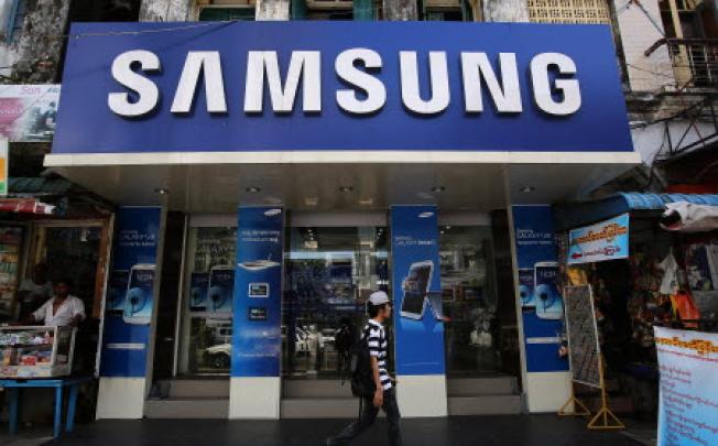 A pedestrian walks past a Samsung Electronics retail store in Yangon, Myanmar, on November 20, 2012. Photo: Bloomberg