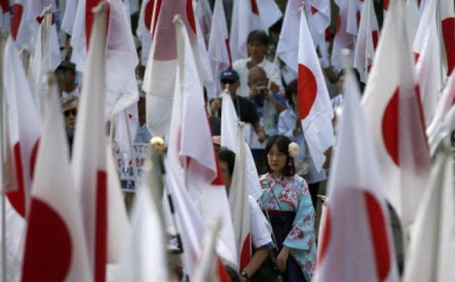 People holding Japanese national flags take part in a recent anti- China rally in Tokyo. Photo: Reuters 