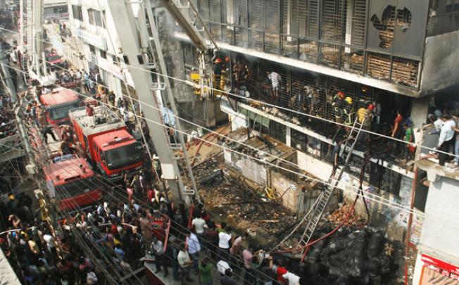 Bangladesh firefighters quell a garment factory blaze on Monday as the country mourns the death of 110 workers in a weekend blaze at another apparel plant, the export industry's worst-ever accident. Photo: AFP