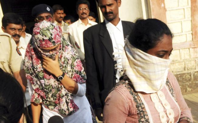 Shaheen Dhada (left) and Renu Srinivas, Indian women arrested for their Facebook posts, come out of a court in Mumbai on November 20. Photo: AP