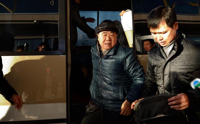Mo Yan (left) arrives at the Beijing Capital International Airport on his way to Sweden to accept the Nobel literature prize. Photo: Xinhua