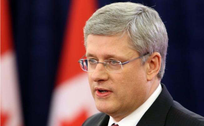 Canadian Prime Minister Stephen Harper announces his governrment's approval of the takeover of the Canadian oil-sands firm Nexen by China's state-owned oil and gas producer CNOOC on Friday. Photo: AP
