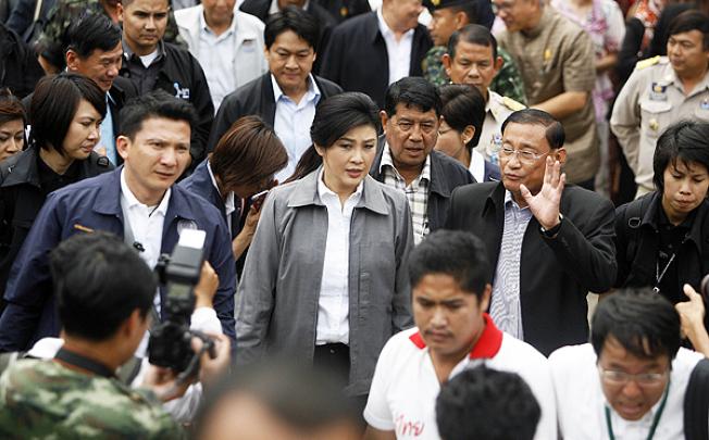 Thai Prime Minister Yingluck Shinawatra walks on her way to a meeting with teachers in Pattani. Photo: AFP