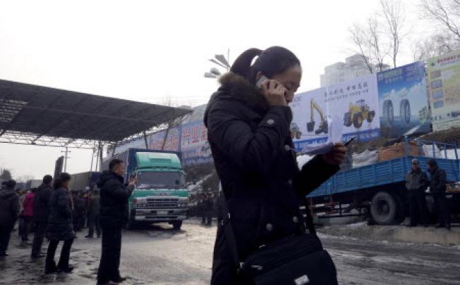 A woman checks the cargo list at a customs port in the Chinese border city of Dandong, Liaoning province, on December 14. Photo: AFP