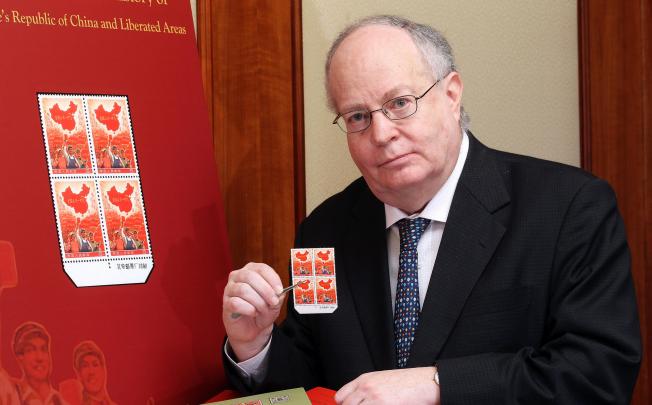 Jeffrey Schneider, director of InterAsia Auctions, holds a block of mainland stamps that were auctioned for HK$6.3 million in December. Photo: Edward Wong