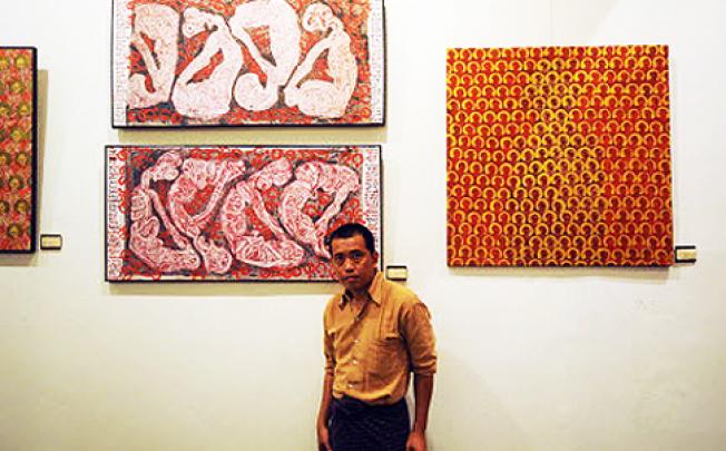  Myanmar artist Htein Lin in front of one of his paintings during an exhibition in Yangon. Photo: AFP 
