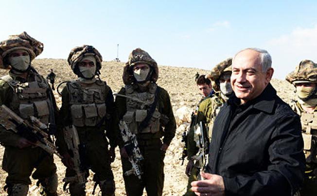 Israeli Prime Minister Benjamin Netanyahu (right) with Israeli soldiers. Israel says it plans to step up arrests of suspected militants in the occupied West Bank to prevent further unrest. Photo: EPA
