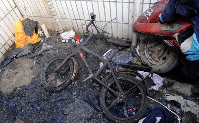 A damaged bicycle at the scene of the fire. Photo: Xinhua