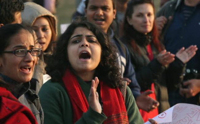 University students shout slogans as they form a human chain advocating safety for women in New Delhi. Photo: AP