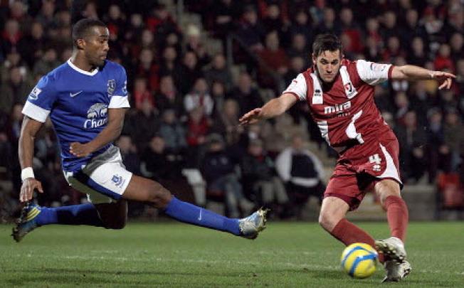 Cheltenham Town's Darren Carter (right) shoots under pressure from Everton's Sylvain Distin during the English FA Cup Third Round soccer match at the Abbey Business Stadium, Cheltenham on England. Photo:  AP