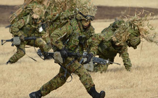 Japanese Self Defense Force ground troops participate in a new year military drill at the training grounds in Narashino. Photo: AFP