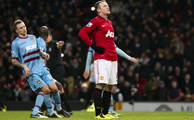 Manchester United's Wayne Rooney reacts after missing a penalty against West Ham. Photo: AP