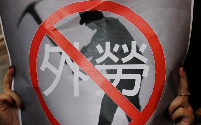 A protester's poster says no to foreign labour. Photo: K. Y. Cheng