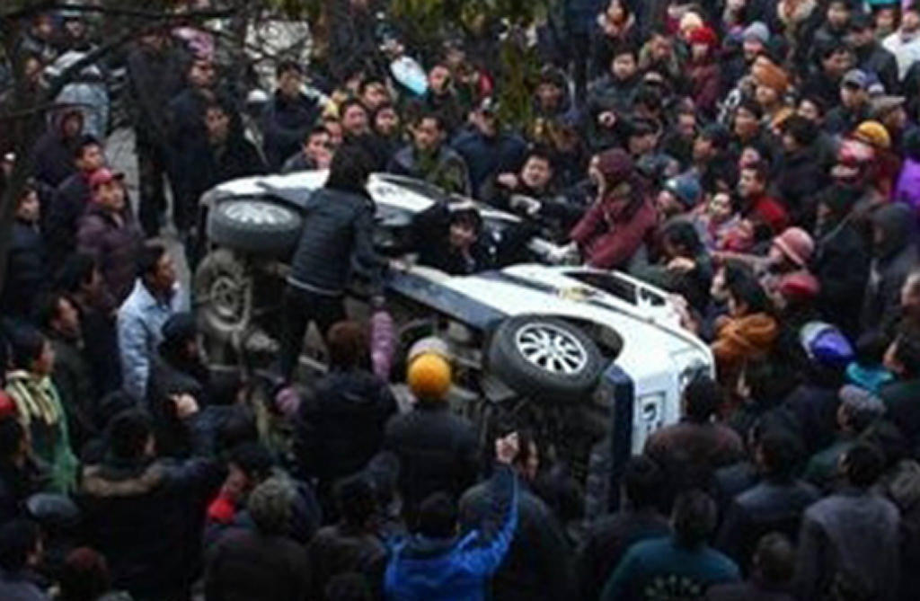 A police car was overturned by relatives in the protest.