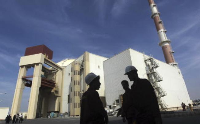 Iranian workers stand in front of the Bushehr nuclear power plant, about 1,200km south of Tehran. Photo: Reuters
