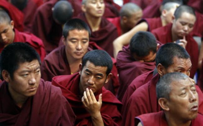 Exiled Tibetan Buddhist monks listen to a speaker in New Delhi, India. Photo: AP