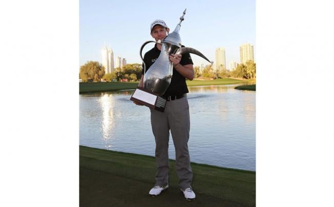 Stephen Gallacher shows off his Dubai trophy. Photo: EPA