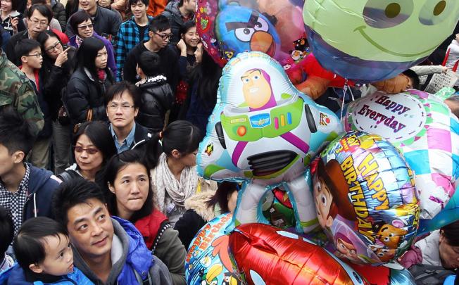 Visitors indulge the festive colour at Victoria Park's Lunar New Year fair. Photo: Sam Tsang