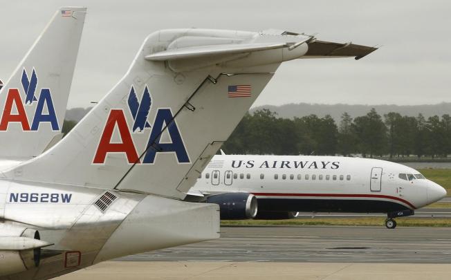 A US Airways plane passes American Airlines planes at Ronald Reagan National Airport in Washington. Photo: Reuters