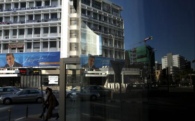 A campaign banner of presidential candidate George Lillikas sprawled across a building in the Nicosia central business district in Cyprus. Photo: AFP