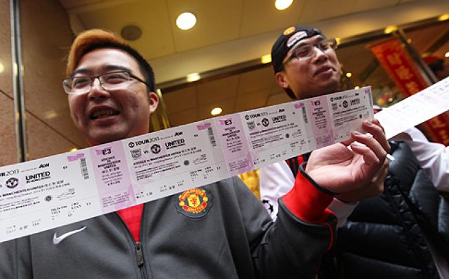 Manchester United fans Jeff Chan Tsz-ho (left) and Jacky Lau display their tickets for the Kitchee vs Manchester United friendly match on July 29. Photo: Nora Tam