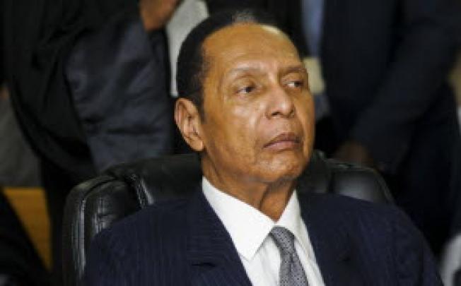Former Haitian Dictator Duvalier listens as his defense council testifies during an appeals court hearing in Port-au-Prince. Photo: Reuters