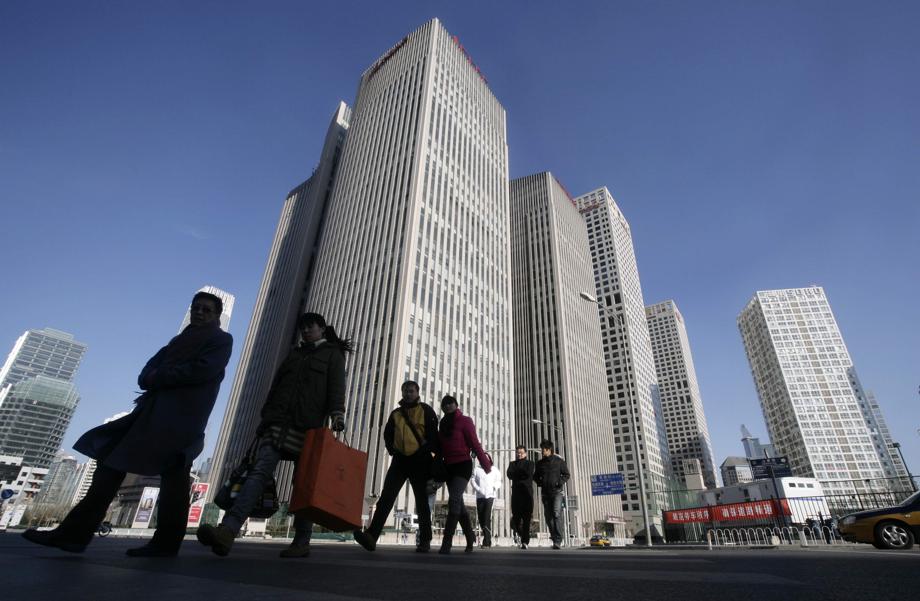 People walk near office buildings in Beijing's central business district. Photo: Reuters